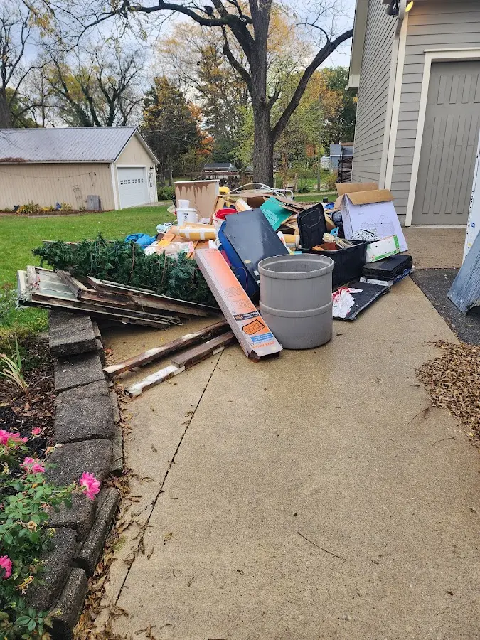 Dumpster being loaded with debris for Estate Cleanout Dumpster Rental in Kerman